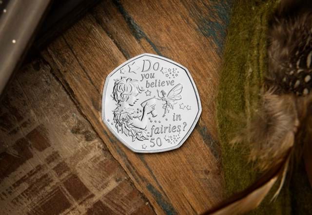 The 2020 Official Peter Pan 50p Coin on wooden surface