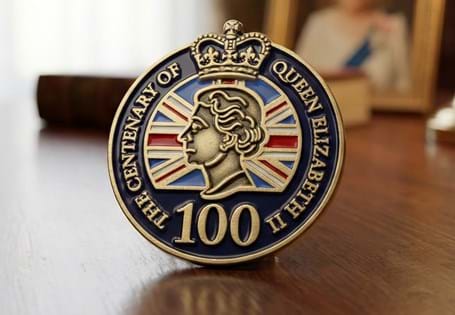 This pin badge has been issued to mark the centenary of Elizabeth II' s birth. The pin badge features a portrait of the Queen which has been coloured with enamel. 